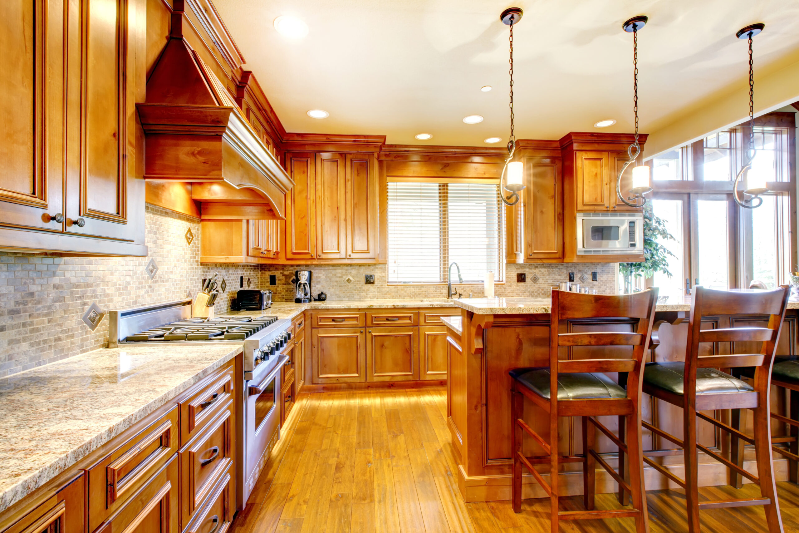 Brilliant kitchen with stained wood cabinets and hardwood floor.
