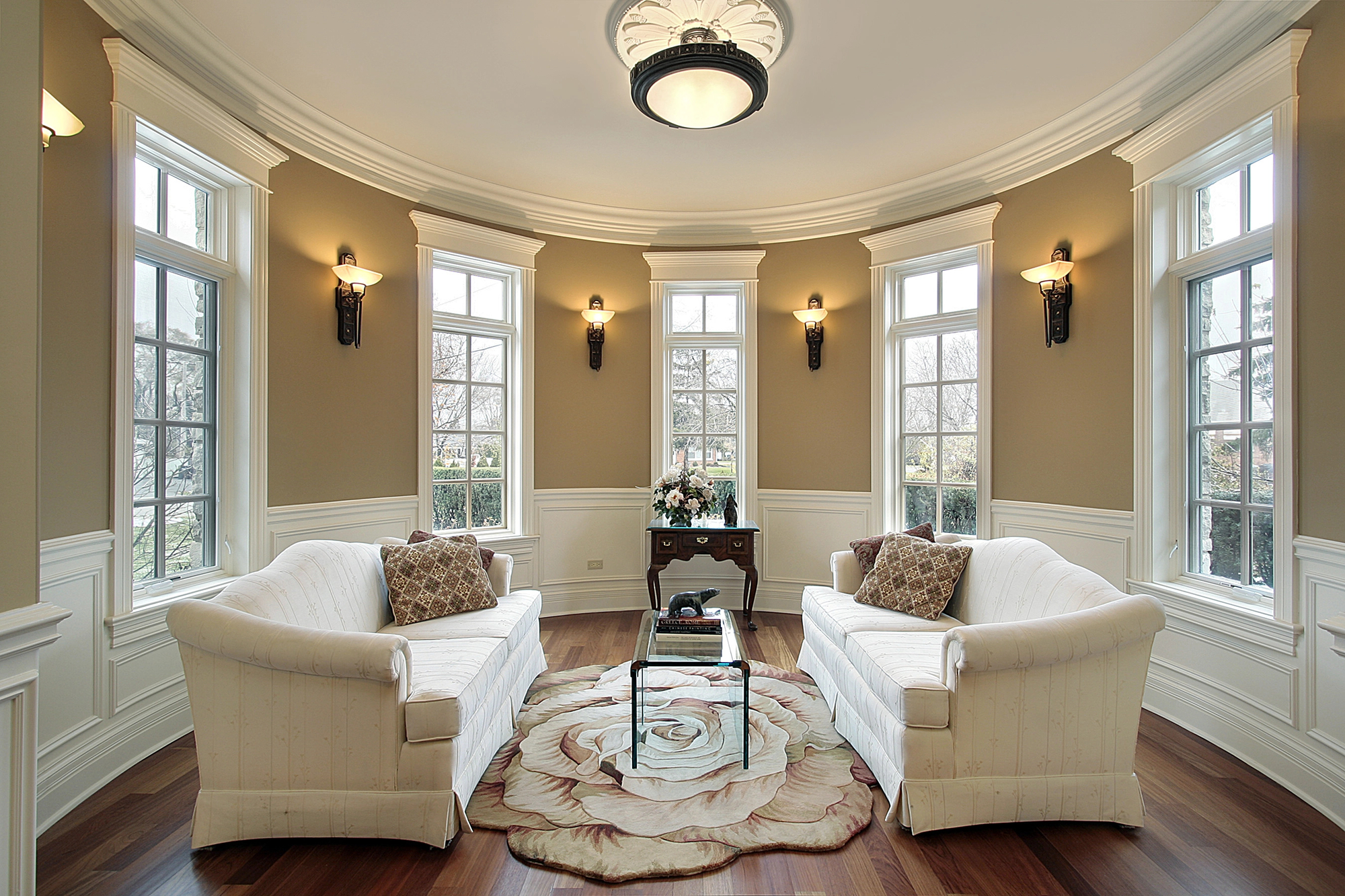 Elegant living room interior with white sofas and a floral rug