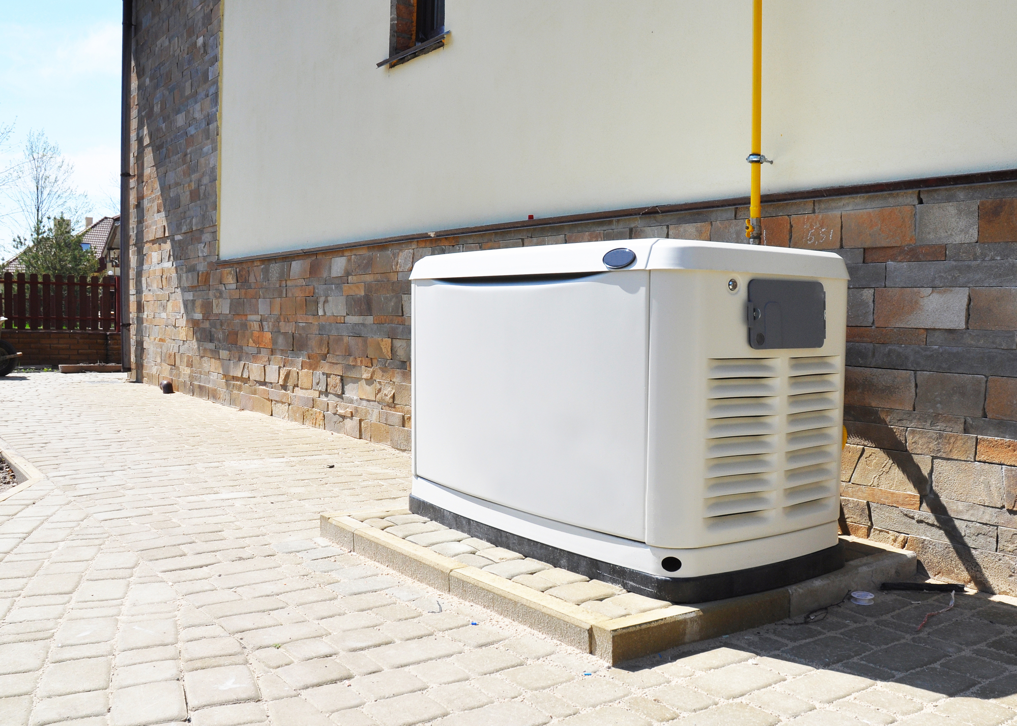 Standby home generator installed on the side of a house